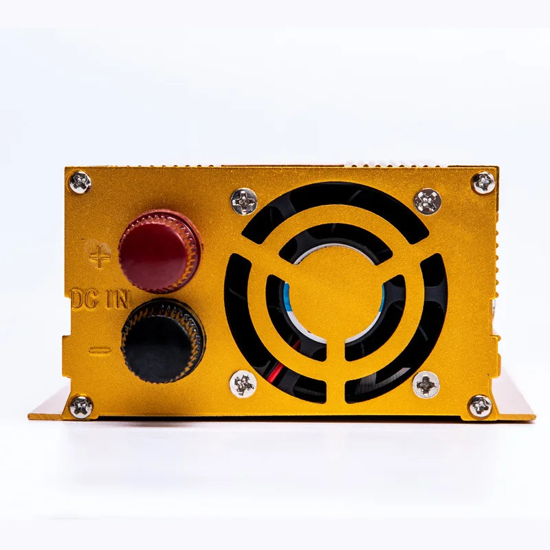 Gold-coloured power inverter side panel with cooling fan and red and black DC input terminals.