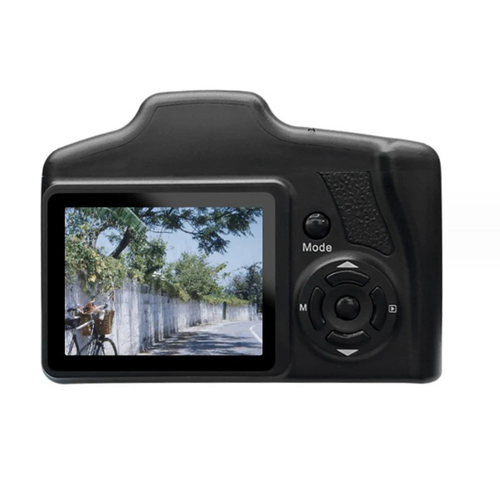 Black plastic digital camera showing a street scene on its rear LCD screen with mode and navigation buttons.