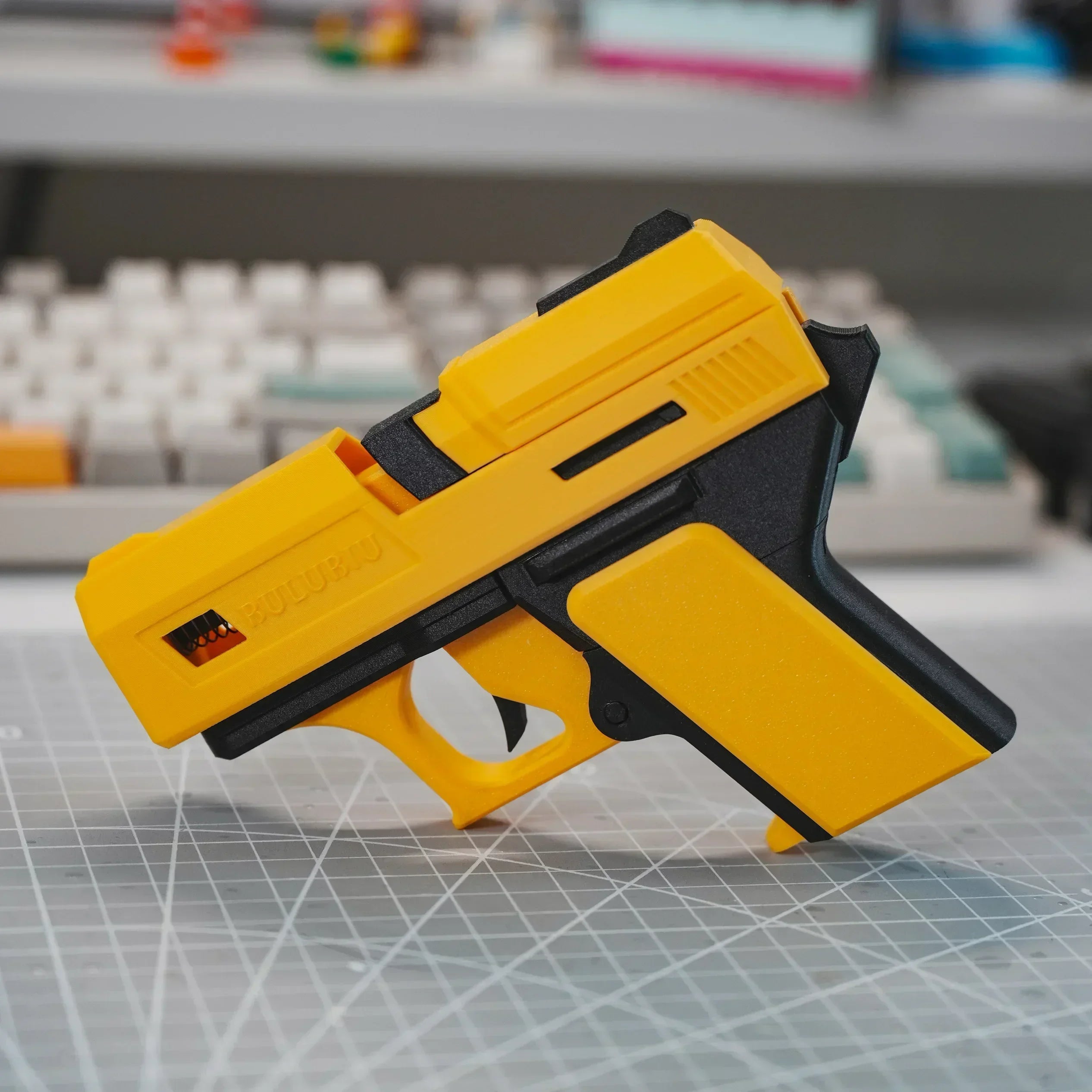 Novelty yellow and black plastic AirPods case, shaped like a toy pistol. Compatible with standard AirPods.