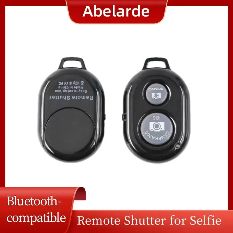 Two black plastic Bluetooth remote camera shutters with iOS and Android buttons for wireless phone photography.