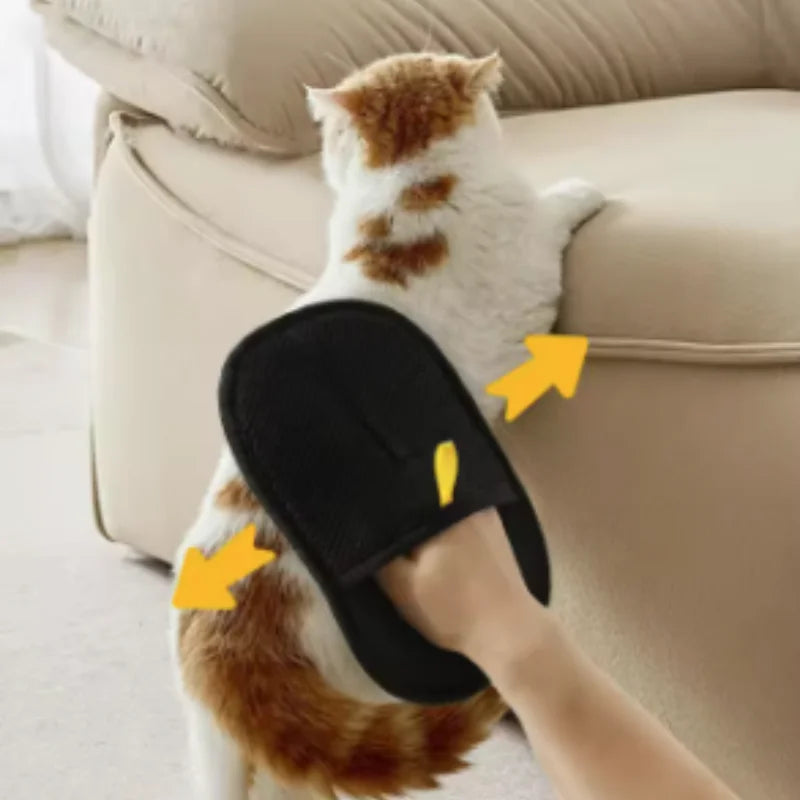 A black pet grooming mitt being used to brush a white and ginger cat. Includes yellow arrow indicators for movement.