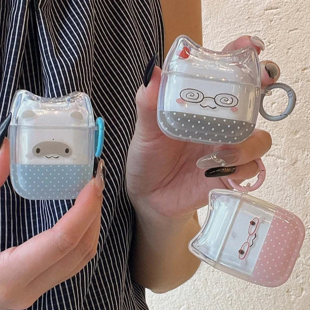 Clear cat-ear AirPods cases with polka dot designs and matching keyrings in pink, blue, and grey.