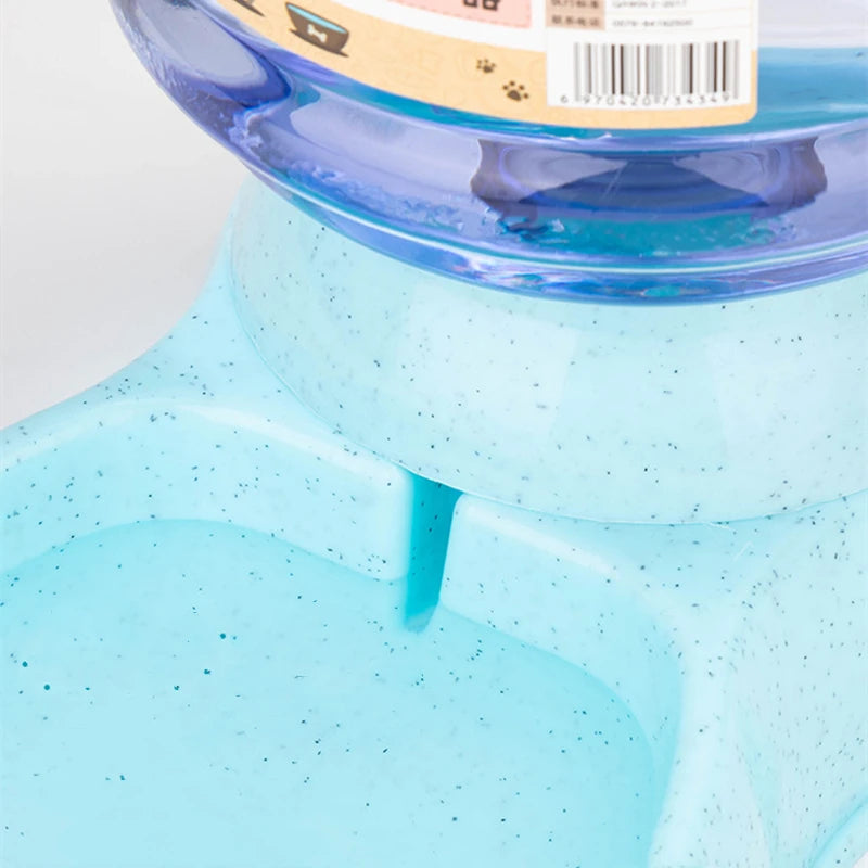 Light blue speckled automatic pet water dispenser with a clear blue water jug.