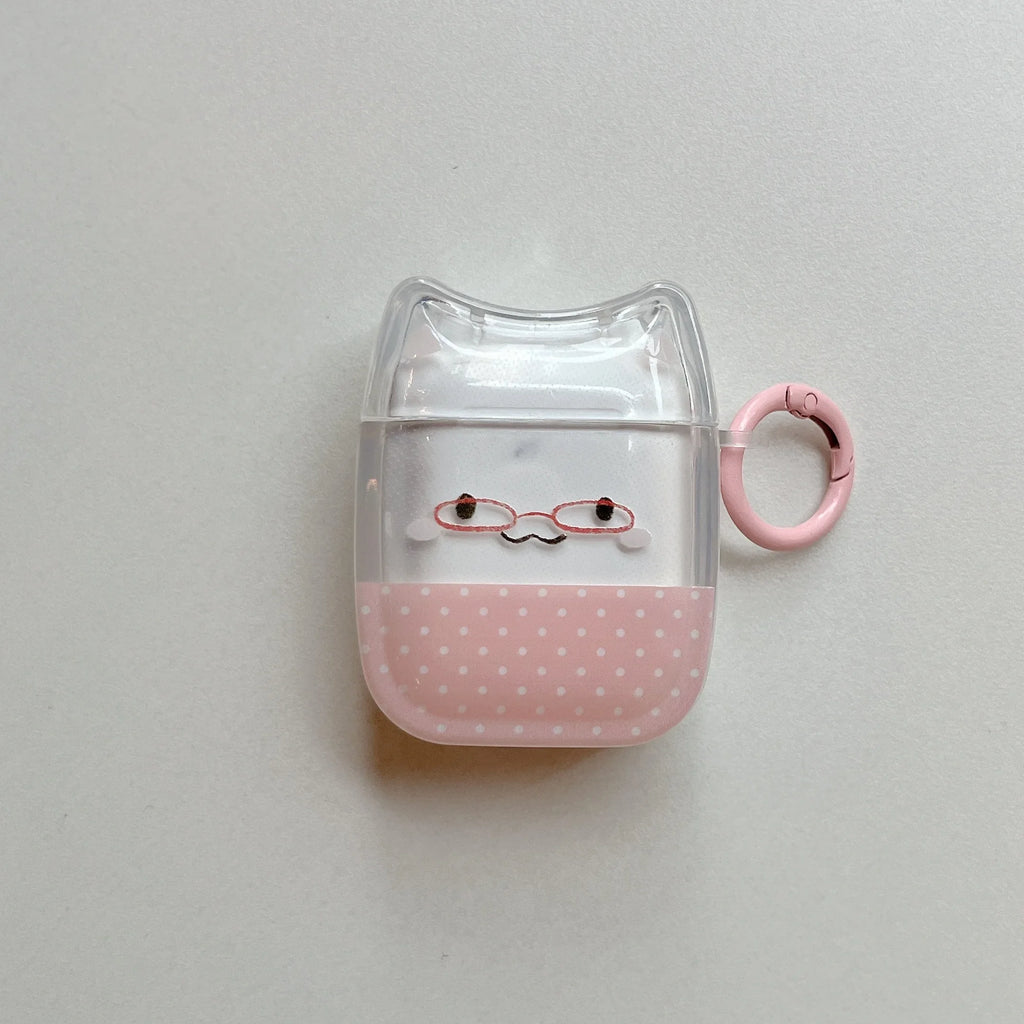 Clear cat-shaped AirPods case with pink polka dot base, glasses motif, and matching pink keyring.