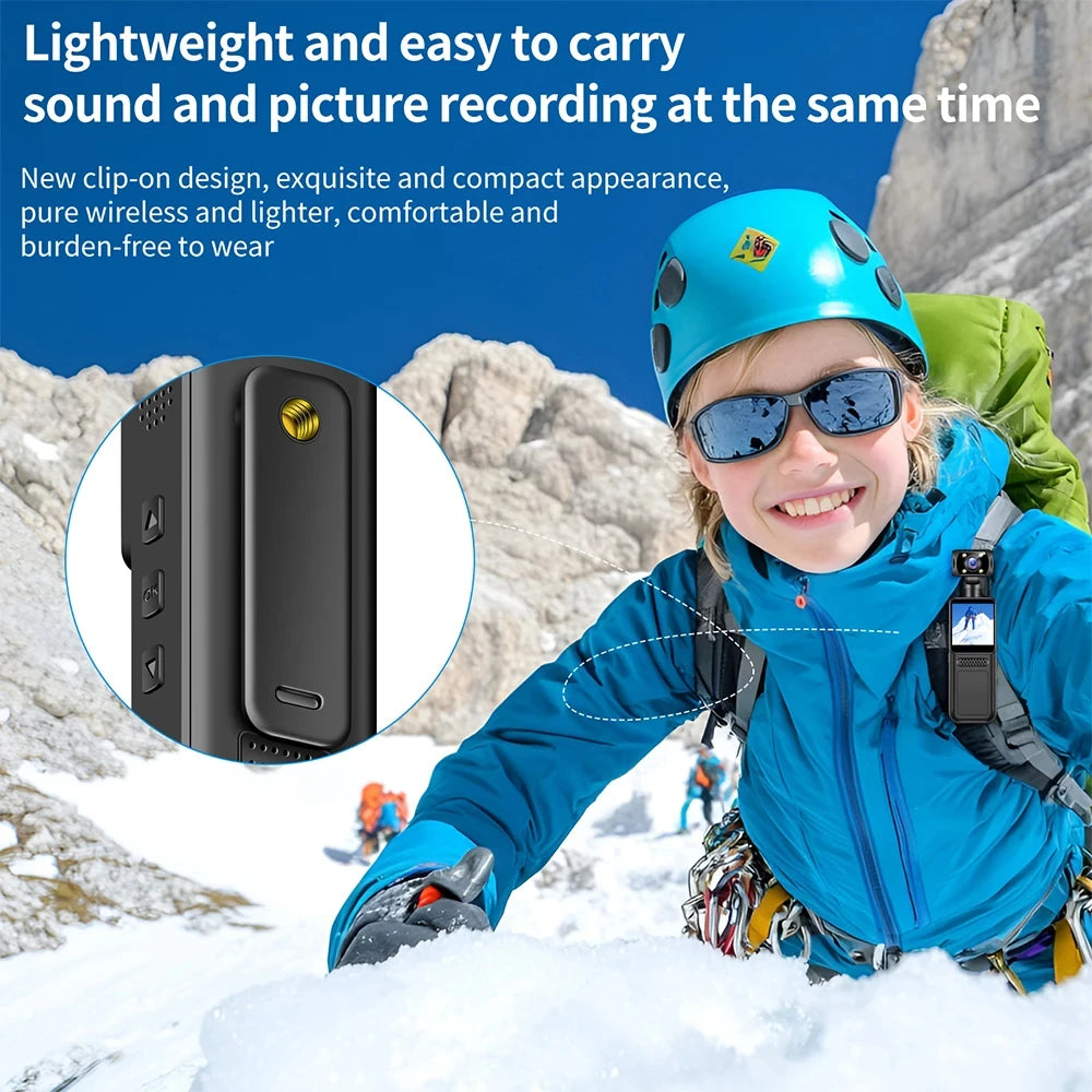Small black plastic body-worn video camera with a clip, shown mounted on a jacket strap for outdoor use.
