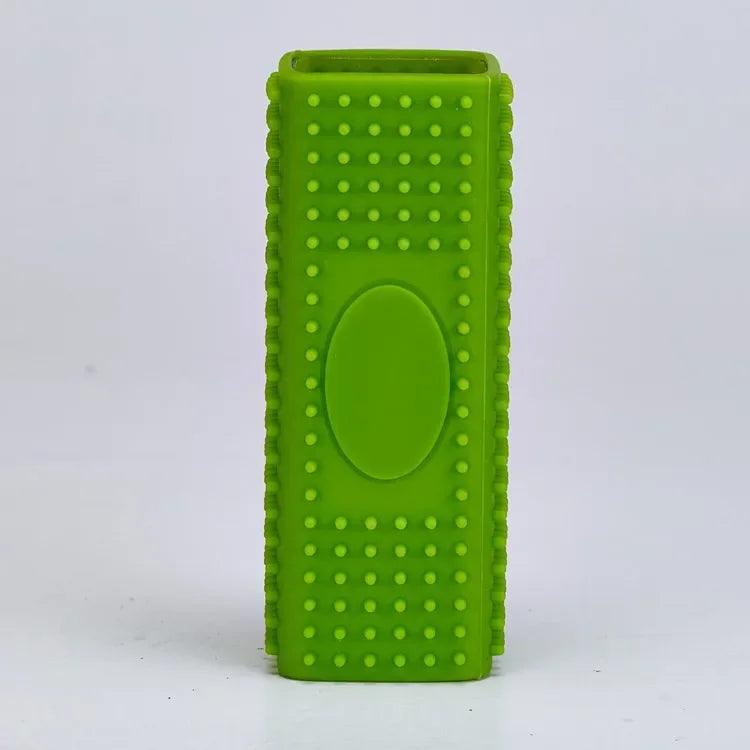 Rectangular, bright green silicone dog toothbrush toy with a textured surface and central oval detail.