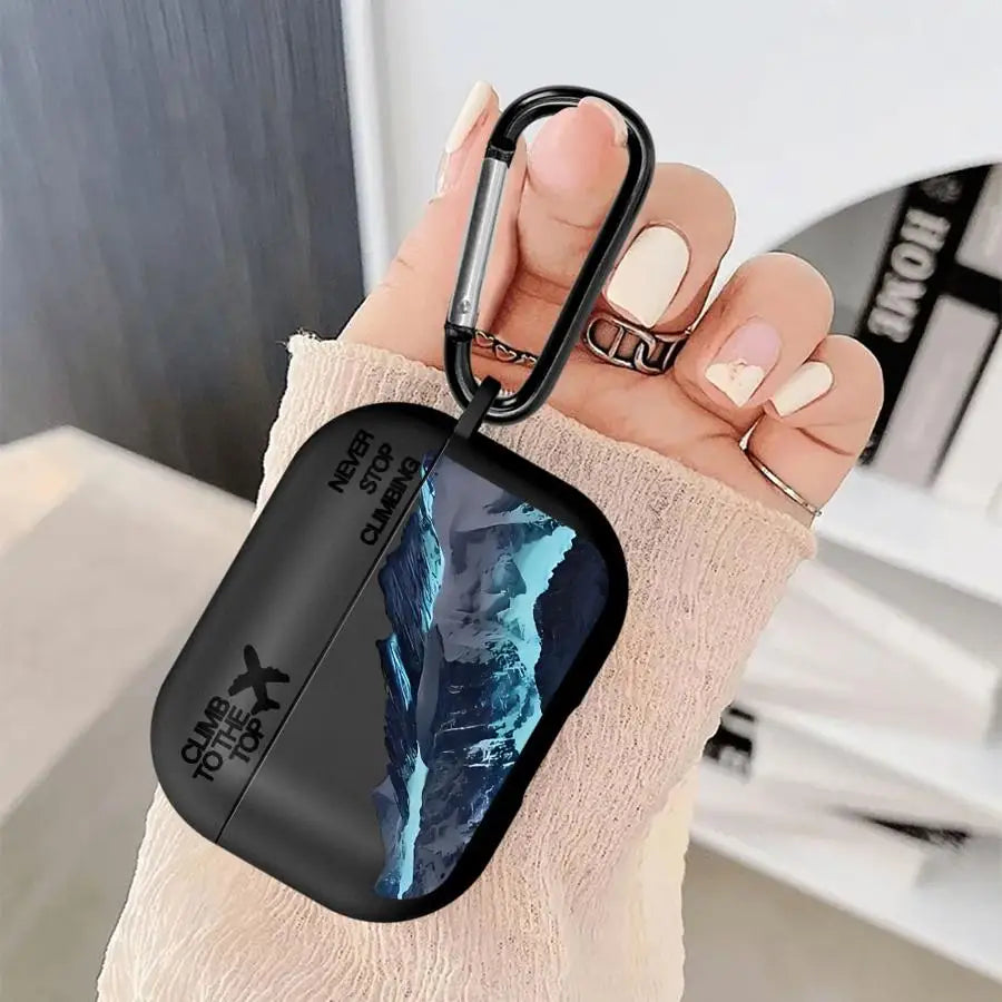 Black matte AirPods Pro case featuring a mountain graphic and 'Never Stop Climbing' text, complete with a carabiner.
