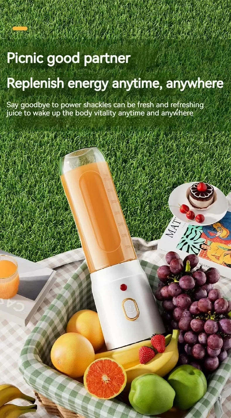 Portable white blender with gold accents, containing orange juice, in a picnic basket with fruit.