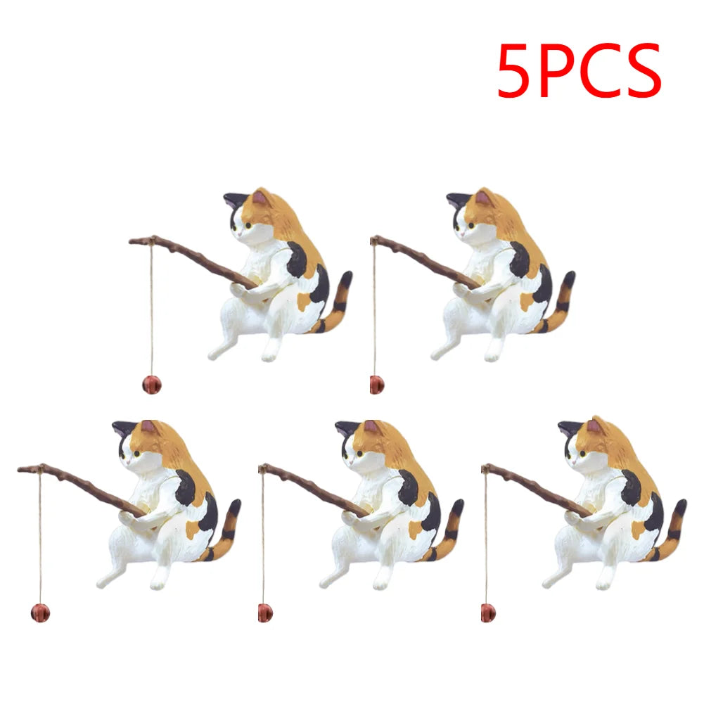 Five calico cat aquarium ornaments, each holding a miniature fishing rod with a tiny bobber.