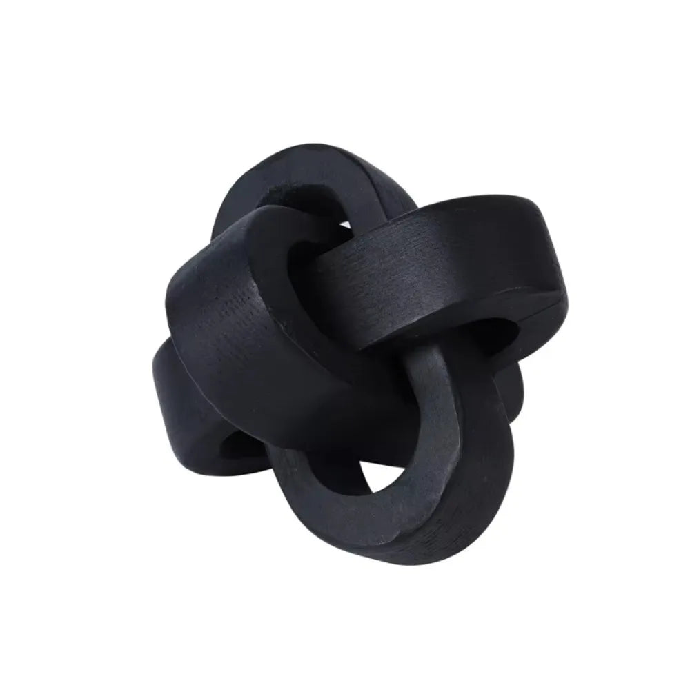 Matte black decorative wooden knot sculpture with an interlocking circular design on a plain white background.