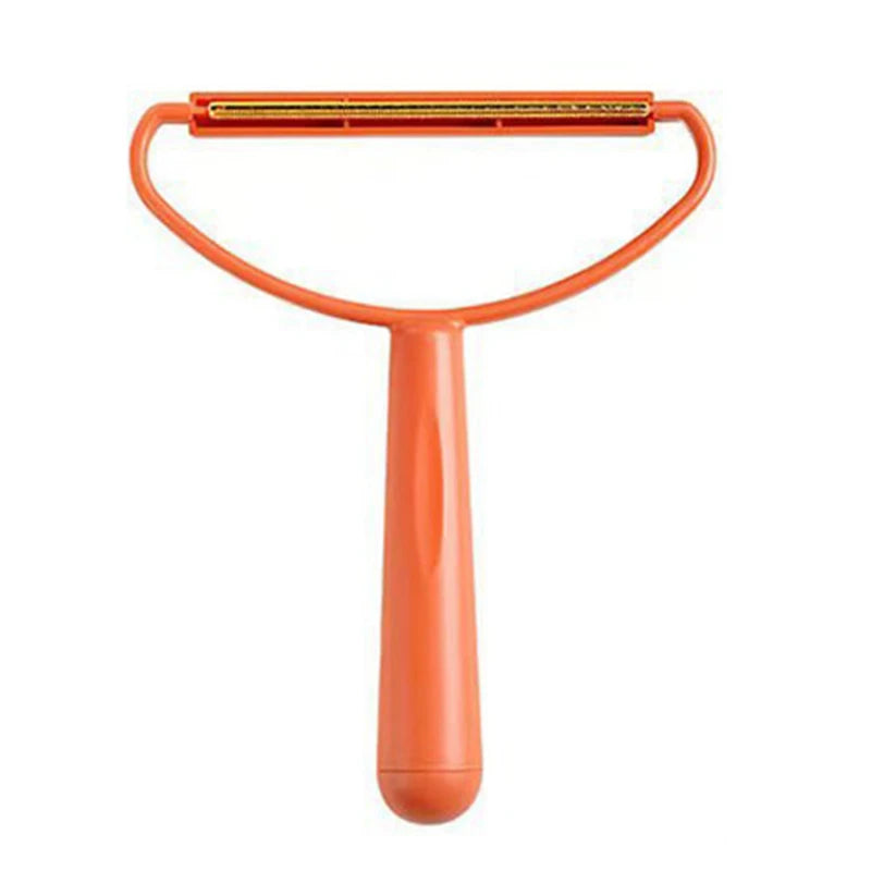 Orange fabric lint remover with a long handle and gold-toned metal scraping edge on a white background.