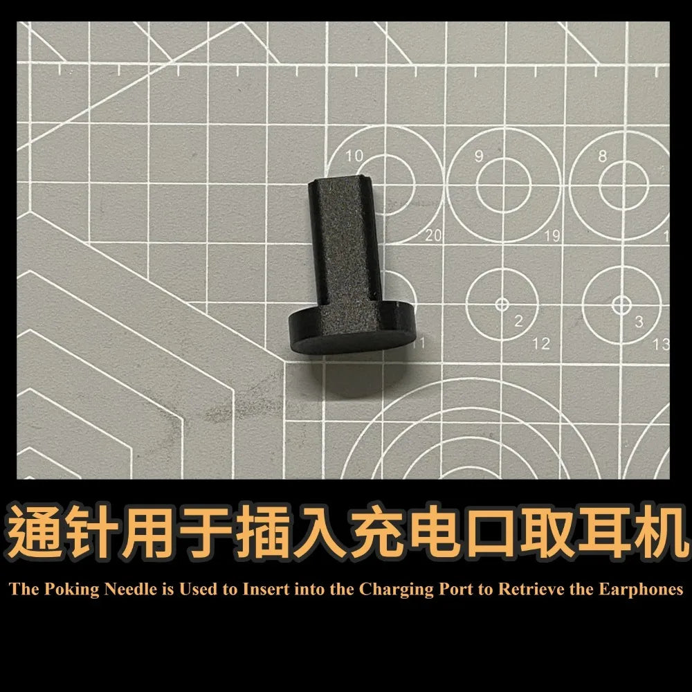 Black plastic tool for extracting AirPods from a charging case, shown on a cutting mat.