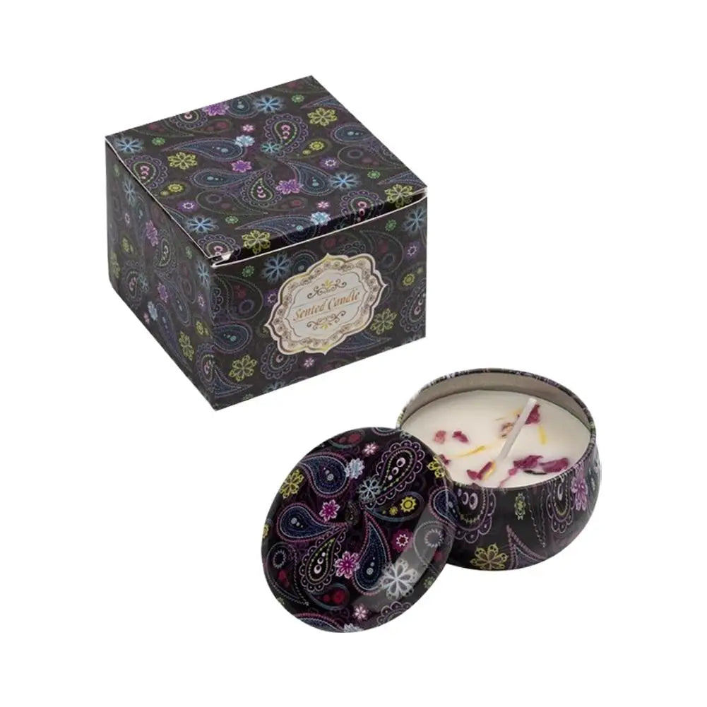 Scented candle in a colourful paisley-patterned metal tin with matching box, featuring dried petals inside.