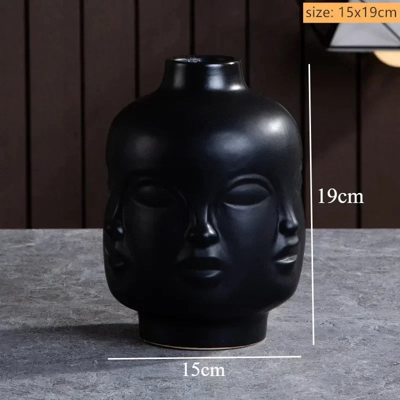 Matte black ceramic vase featuring a unique multi-face sculptural design. Height 19cm, diameter 15cm.