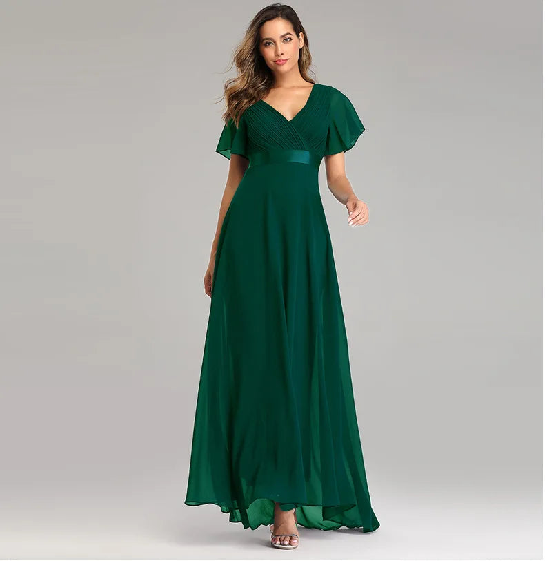 Dark green chiffon maxi dress with V-neck, pleated bodice, flared short sleeves, and a flowing floor-length skirt.