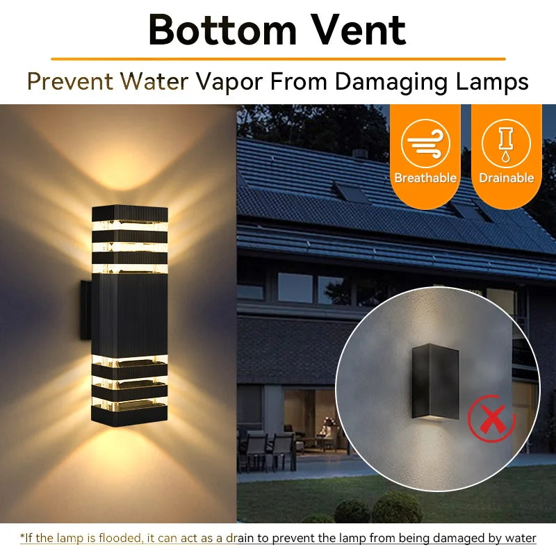 Modern black rectangular outdoor wall light casting warm upward and downward beams, featuring a moisture-draining vent.
