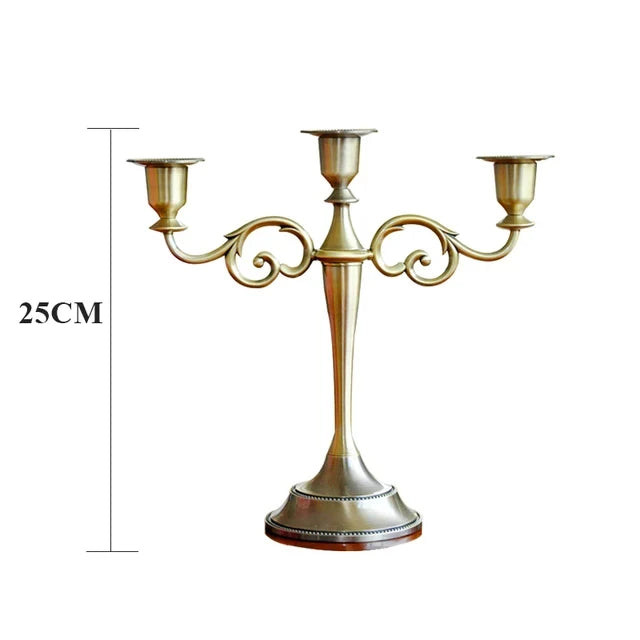 Bronze metal 3-arm candelabra with decorative scroll arms and a tapered stand, 25cm tall.