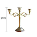 Bronze metal 3-arm candelabra with decorative scroll arms and a tapered stand, 25cm tall.
