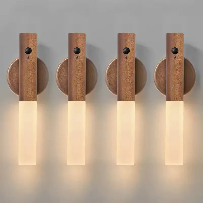 Four rechargeable LED wall lights with a wood-effect finish, integrated motion sensors, and warm glowing diffusers.