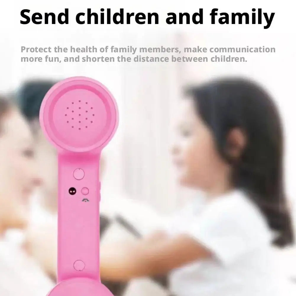 Pink retro-style handheld telephone receiver with integrated control buttons for kids.