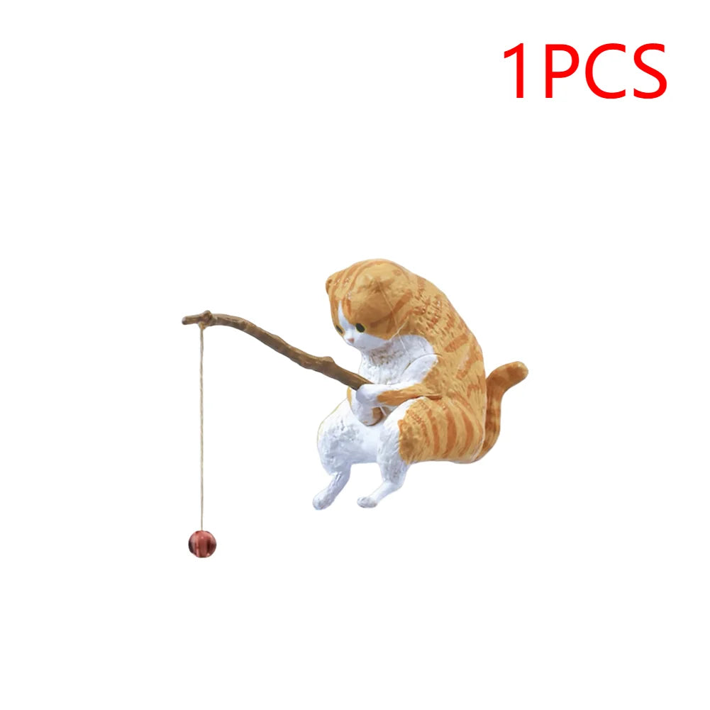 Cute orange tabby cat aquarium ornament holding a wooden fishing rod with a small bead line.