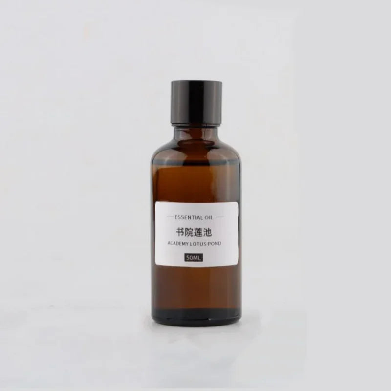 50ml amber glass bottle of Academy Lotus Pond essential oil with a black screw cap and minimalist white label.