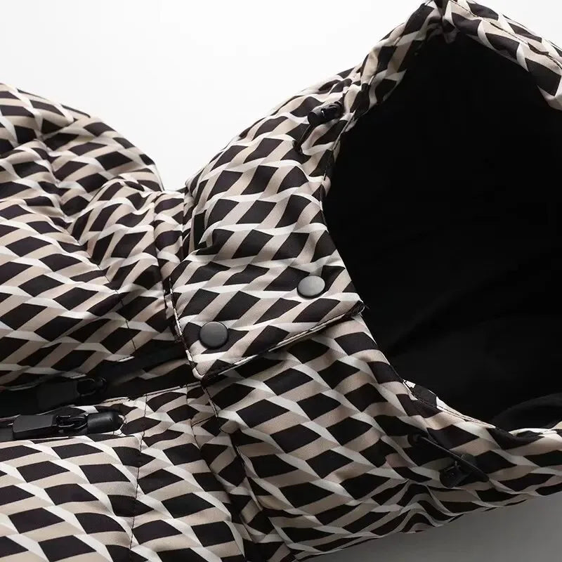 Close-up of a puffer jacket in a black, white, and beige geometric diamond pattern with a hood and black snap buttons.