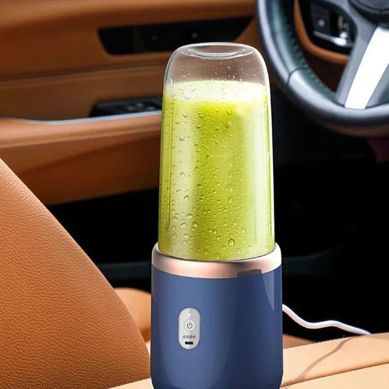 Portable blue and rose gold blender with a clear cup containing green smoothie, set in a car interior.