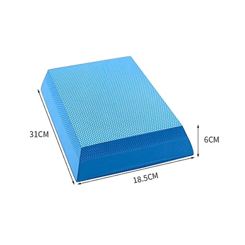 Blue TPE foam balance pad with a non-slip textured surface. Measures 31cm x 18.5cm x 6cm for exercise stability.
