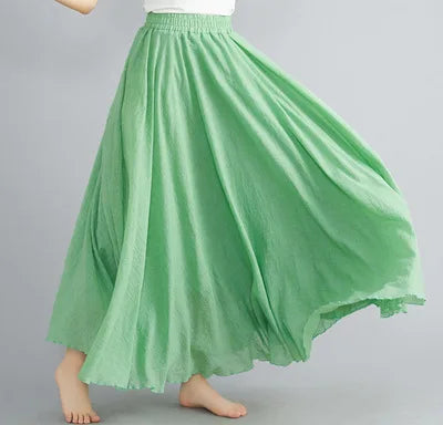 Light green, flowy maxi skirt with an elasticated waistband and gathered, full-length silhouette.