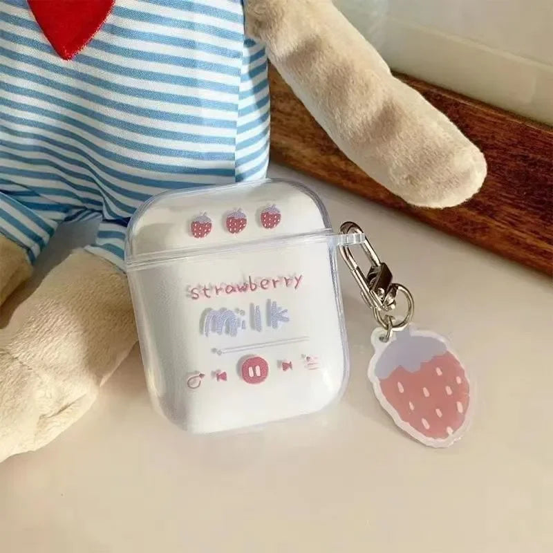 Clear plastic AirPods case with strawberry milk graphic and matching strawberry charm keychain.