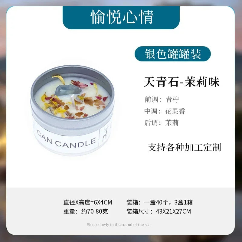 A silver tin candle decorated with dried flower petals and a blue crystal stone.