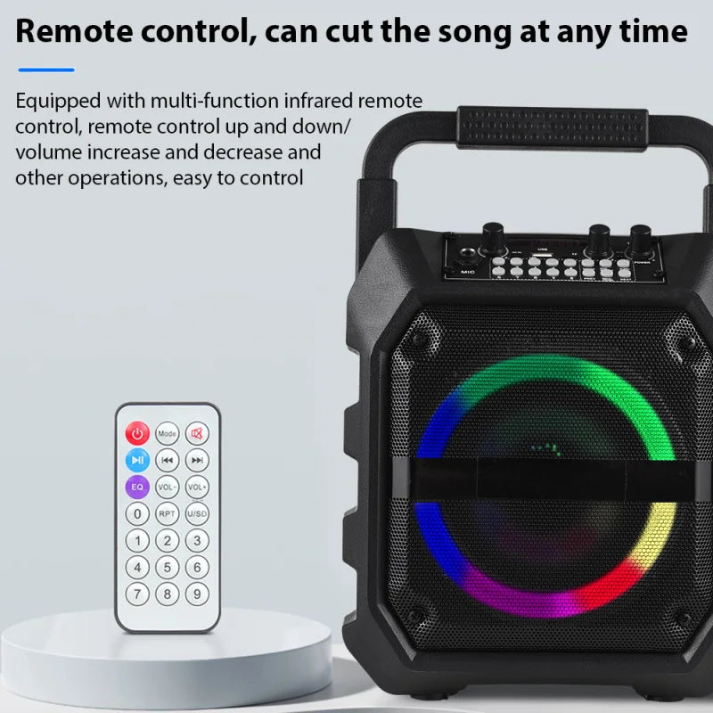 Black portable wireless speaker with a circular LED light, carry handle, control panel, and a remote control.