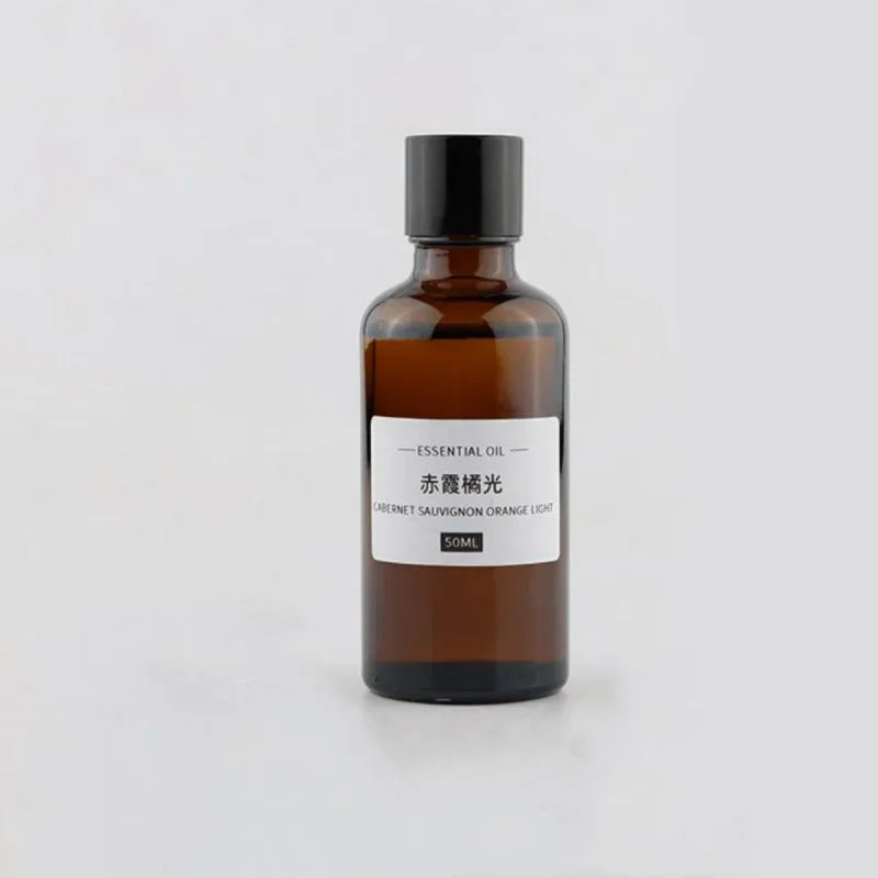 50ml essential oil in an amber glass bottle with a black screw cap and a minimalist white product label.