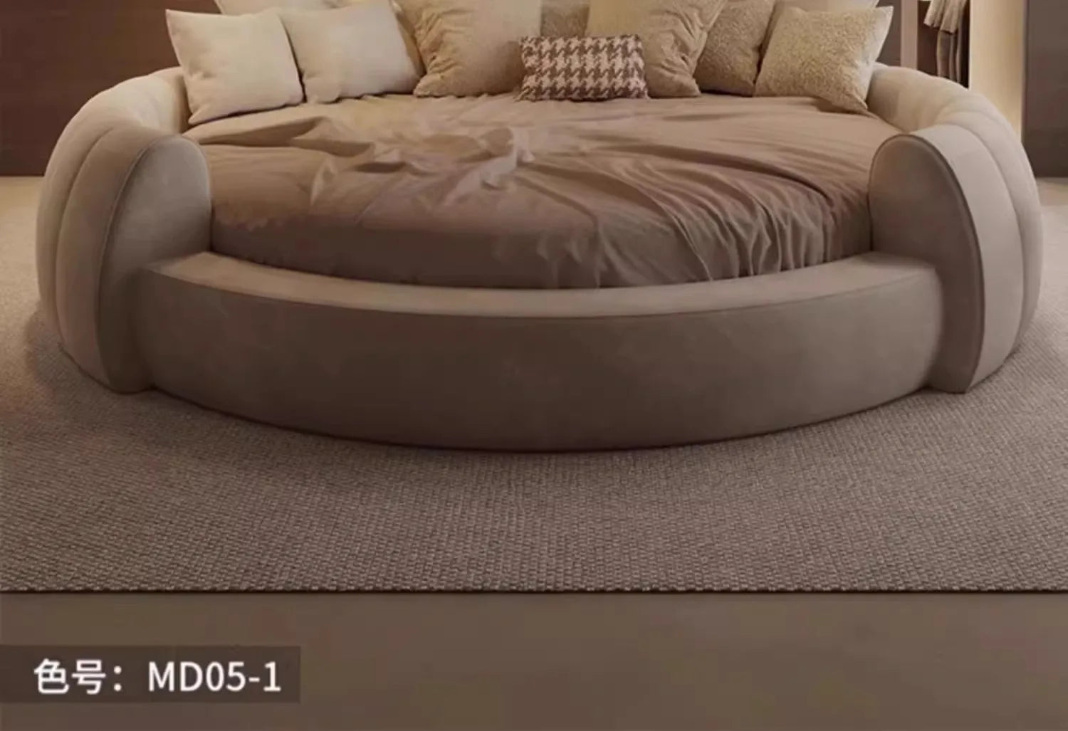 A modern, minimalist circular bed upholstered in soft, beige fabric, styled with neutral cushions.