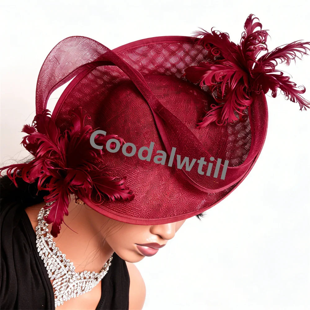 Elegant burgundy fascinator hat featuring a structured mesh brim, sweeping loops and decorative feather accents.