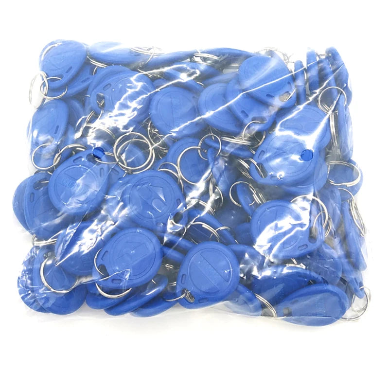 A bulk pack of round, blue plastic RFID key fobs, each with an attached metal split ring, in a clear plastic bag.
