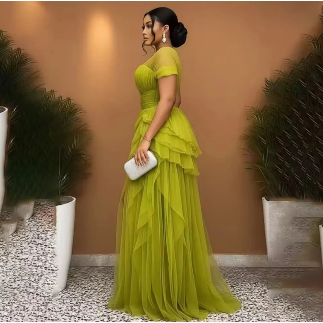 Olive green tulle evening dress with sheer short sleeves, ruched bodice, and layered ruffle skirt.
