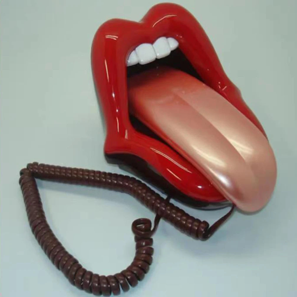 Novelty landline telephone shaped like bright red lips with a protruding tongue and a coiled brown cord.