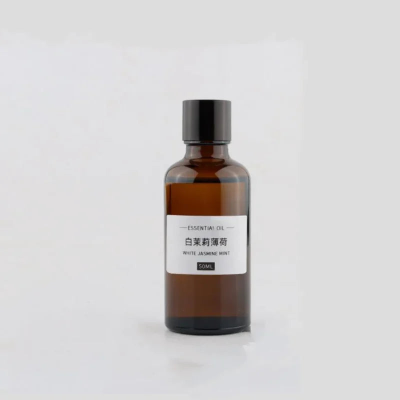 50ml amber glass bottle of White Jasmine Mint essential oil with a black screw cap and simple white label.