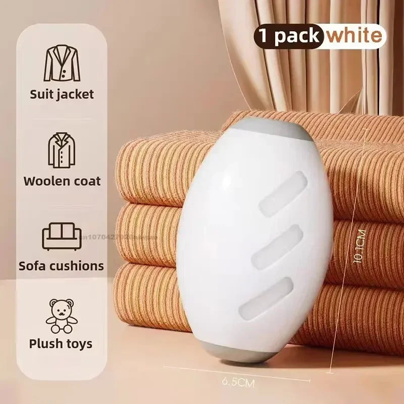 White oval fabric shaver for garments and upholstery, 10.1cm tall, with icons showing use on coats and cushions.