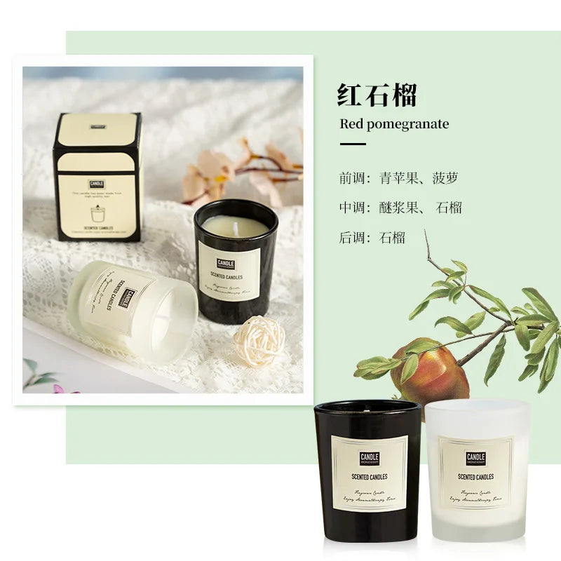 Red pomegranate scented candles in black and frosted white glass jars with minimalist labels.