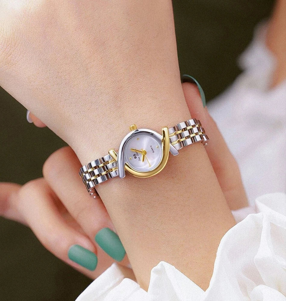 Elegant women’s two-tone silver and gold stainless steel quartz watch with a slim bracelet and curved bezel detail.