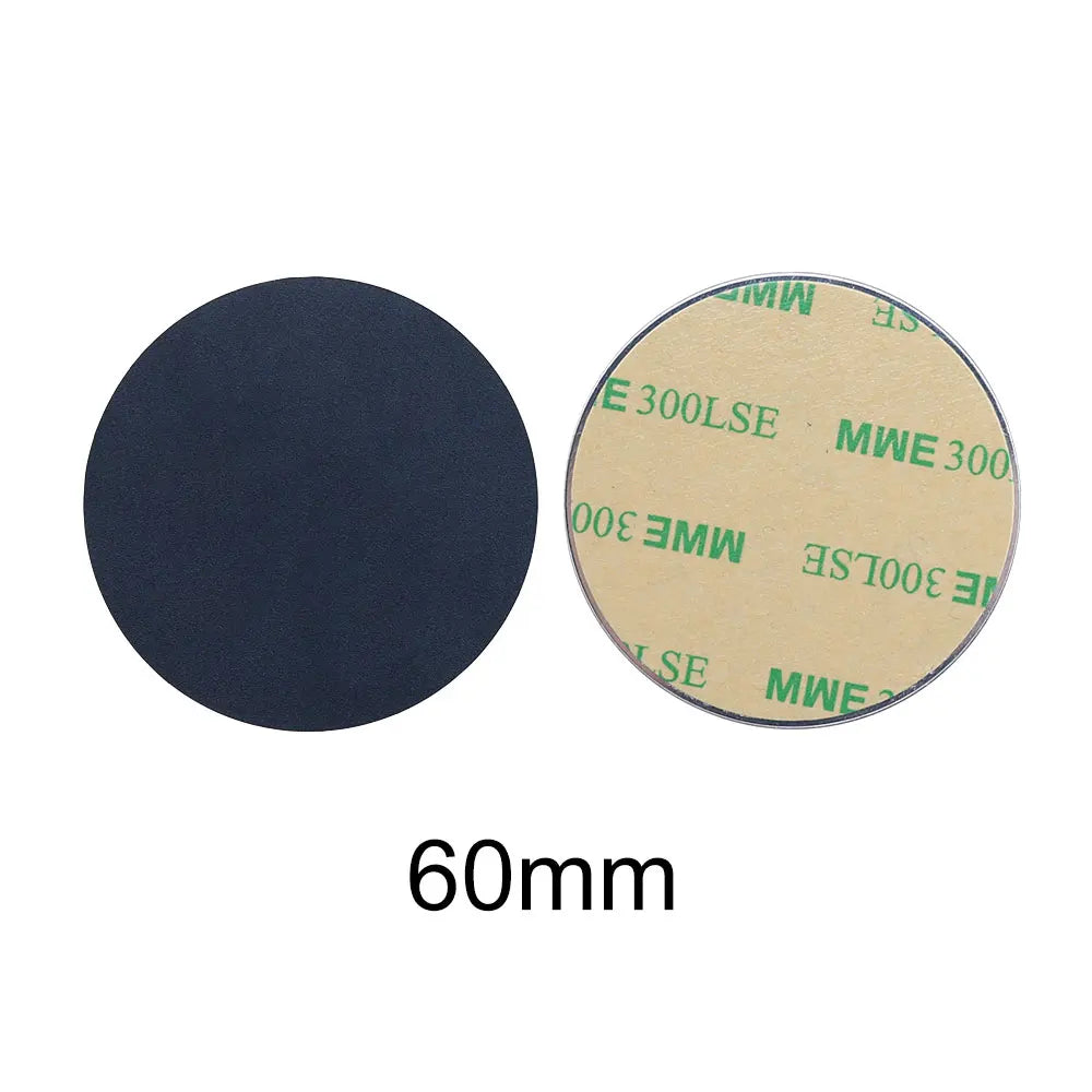 Two 60mm round, black adhesive pads; one shows the dark matte surface, the other the peel-off backing.