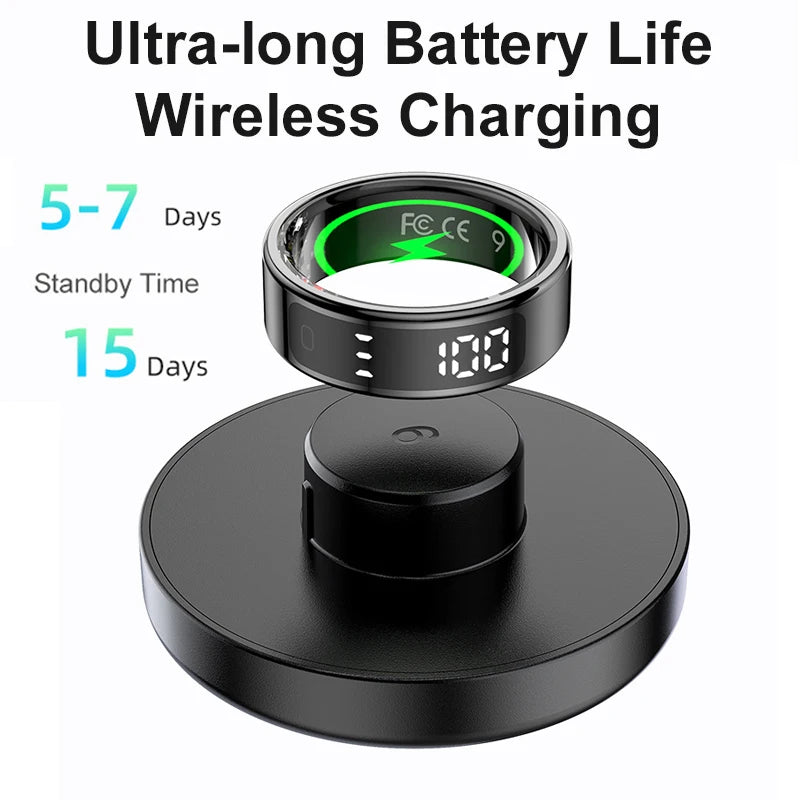 Sleek black smart health ring with a digital touch display, shown on a wireless charging dock with battery info.