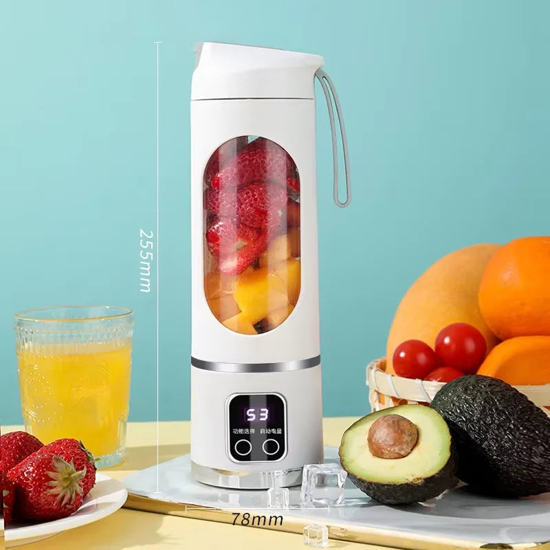 White portable electric blender bottle with a digital display, viewing window filled with fruit, and a carry strap.