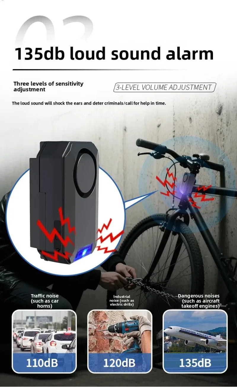 Black plastic bicycle alarm with 135dB sound, adjustable sensitivity, and blue LED light mounted on a bike frame.