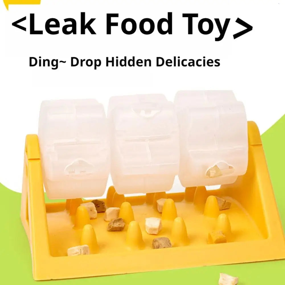 Yellow interactive dog puzzle feeder with three clear rotating treat-dispensing barrels over a textured snack tray.