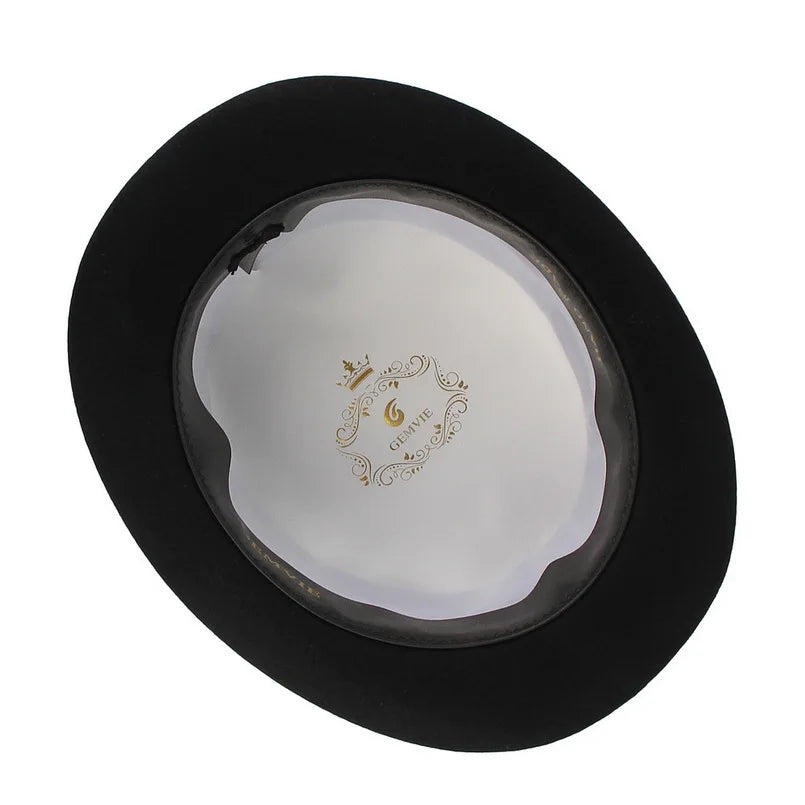 Interior view of a classic black wool bowler hat, featuring a white satin lining with decorative gold detail.