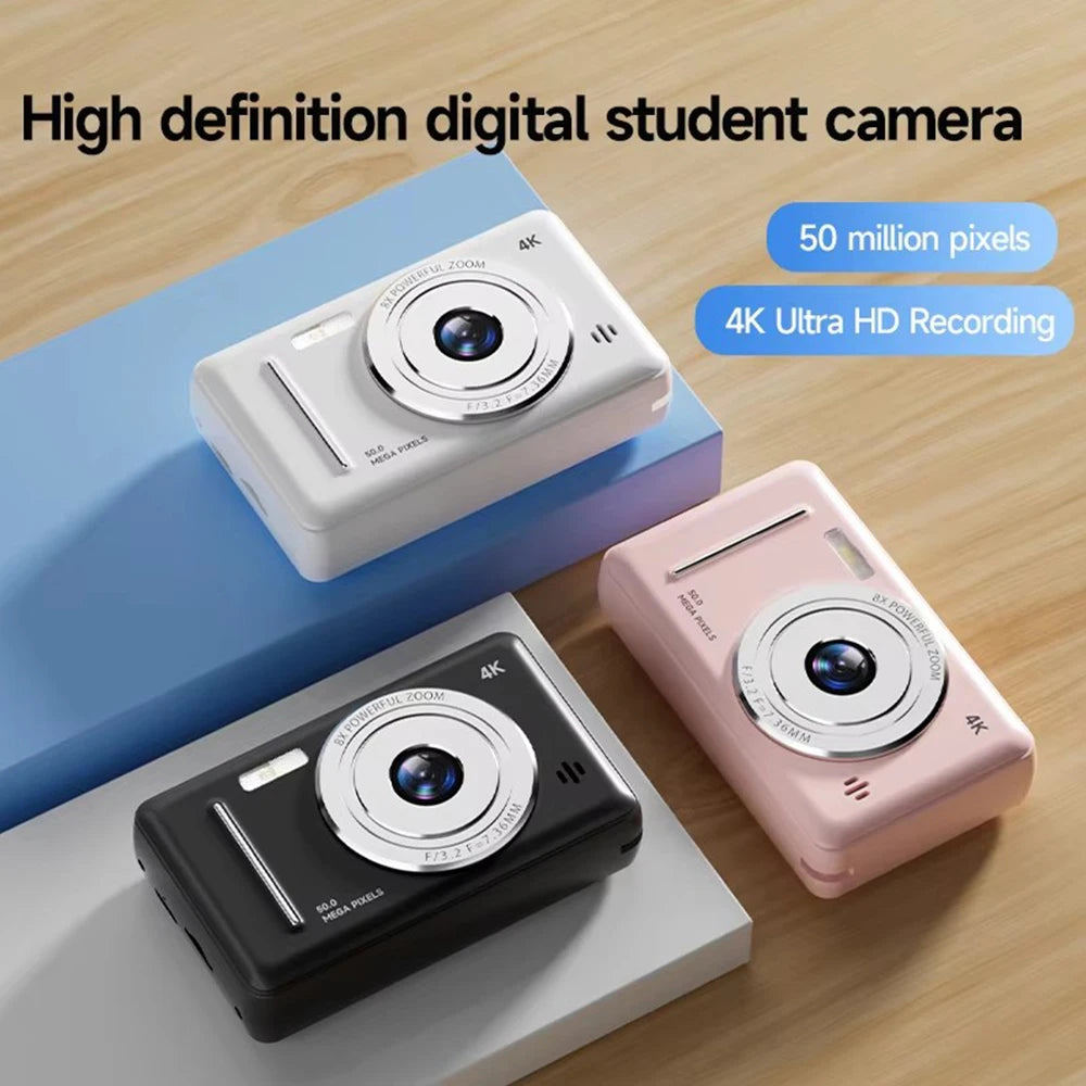 White, black, and pink plastic digital cameras with 4K recording and 50-megapixel lenses on display.